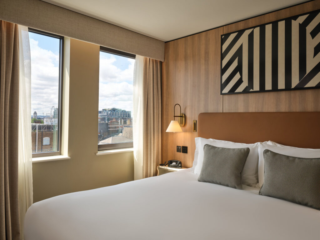 Bed and window view at at Imperial London Hotels